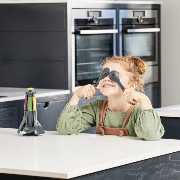 Girl playing with kitchen utensils